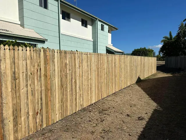 A new paling boundary fence beside a two storey townhouse in Kirwan