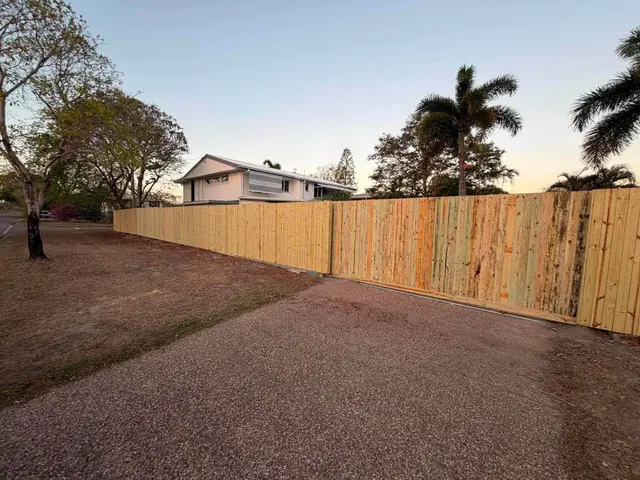 The new Garbutt fence at dusk with palms