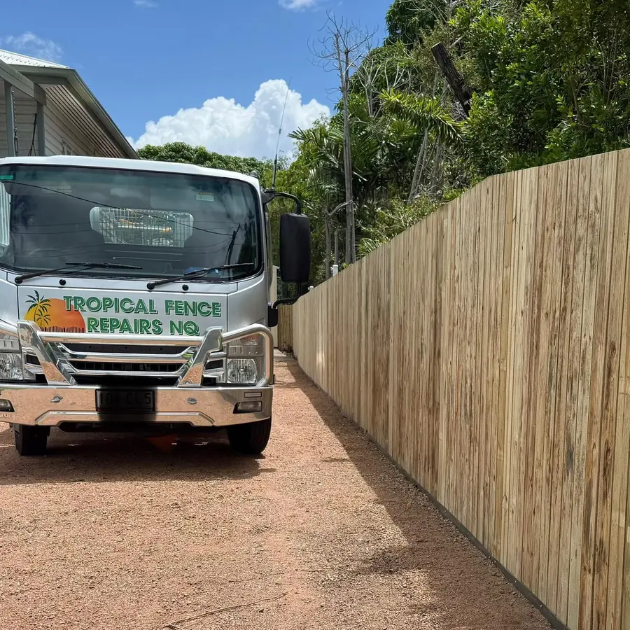 The Tropical Fence Repairs NQ truck parked beside a new timber fence